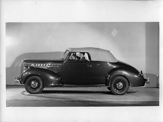 1940 Packard convertible coupe, left side view, top raised