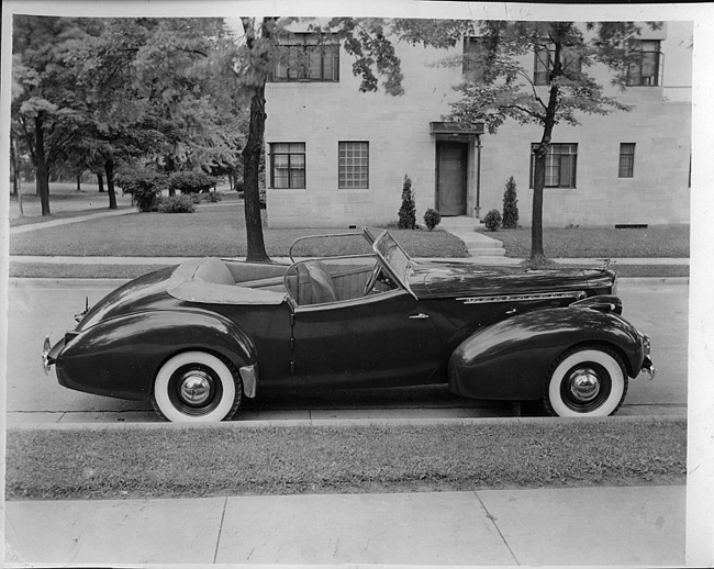 1940 Packard convertible victoria, right side view, top folded, parked on street