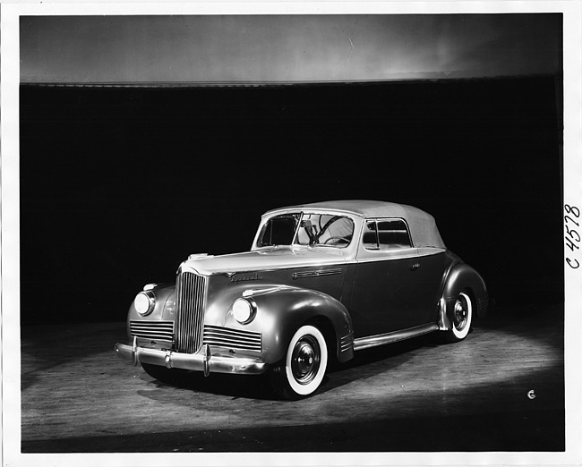 1942 Packard convertible coupe, three-quarter left front view, top raised