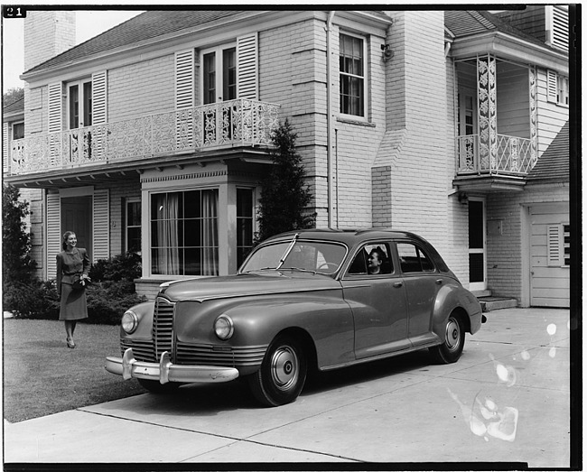 1946 Packard Clipper touring sedan, parked in driveway in front of house
