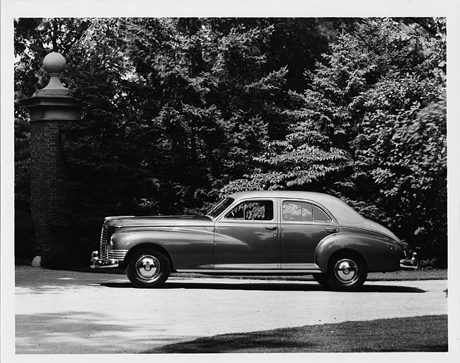 1947 Packard touring sedan, left side view, parked on drive