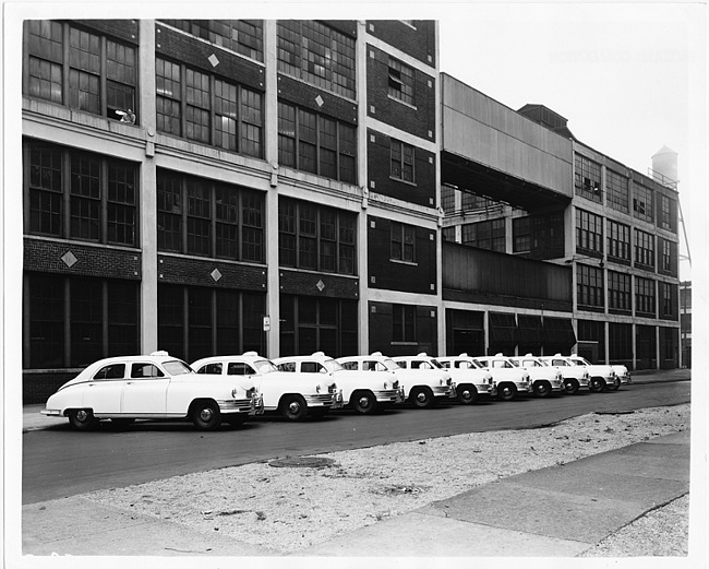 1948 Packard taxicabs, lined up in front of a Packard Motor Car Co. building