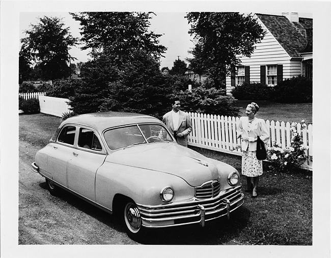 1948 Packard touring sedan, parked on dirt road, house in background