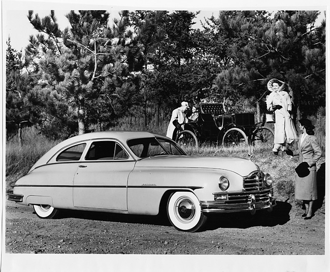 1949 Packard sedan with 1899 Packard Model A in background