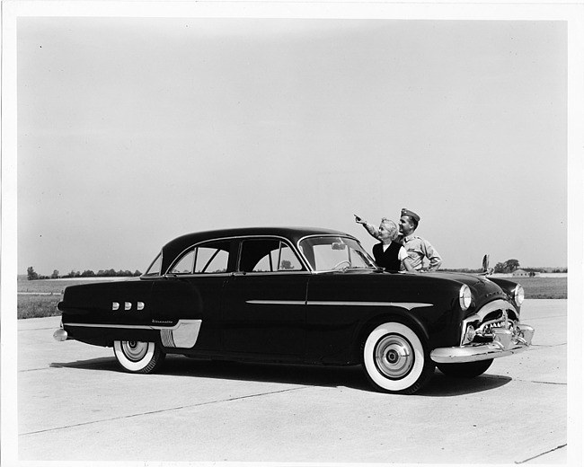 1951 Packard 400 Patrician, couple standing at driver's door