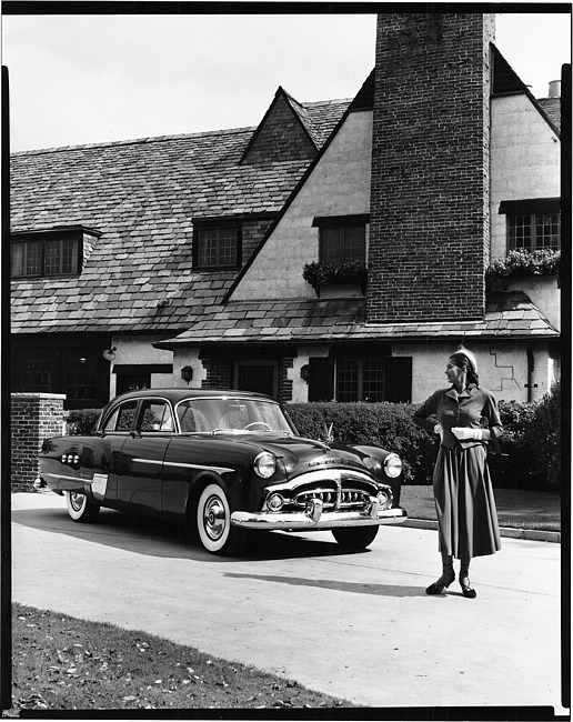 1951 Packard Patrician 400, parked in driveway of house, female standing near front of car