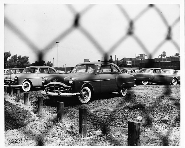 1952 Packard sedan, three-quarter left front view, parked in lot