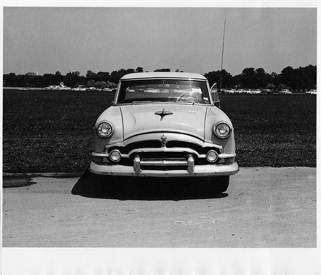 1953 Packard sedan, front view, parked on drive, cars in distance