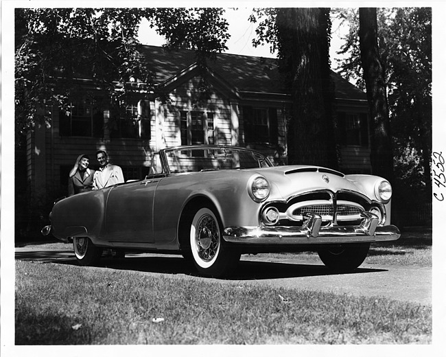 1953 Packard Pan American convertible, parked in driveway, couple in background