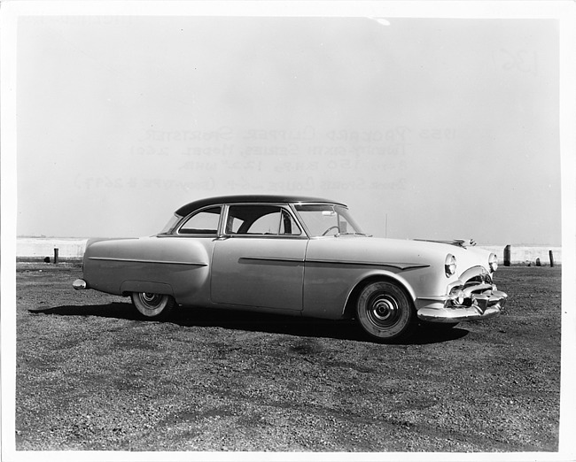 1953 Packard sports coupe, nine-tenths right side view, parked on grass