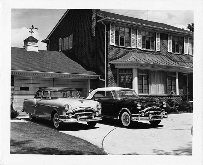 1953 Packards, parked in driveway in front of house