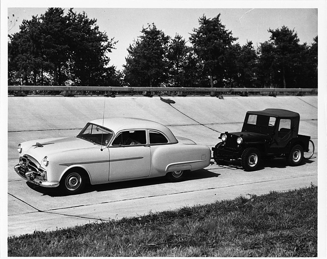 1954 Packard club sedan pulling a jeep at Packard Proving Grounds