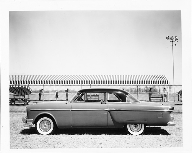 1954 Packard 2-door sedan, left side view, driving range in background