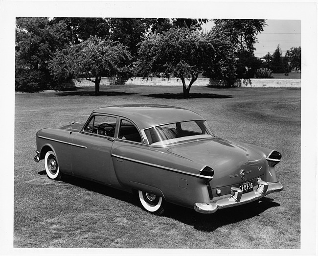 1954 Packard club sedan, three-quarter rear left view, parked on grass