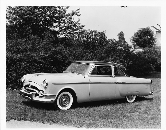 1954 Packard 2-door sedan, seven-eights left side view, parked on grass