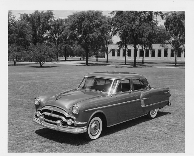 1954 Packard sedan, three-quarter front left view, parked on grass