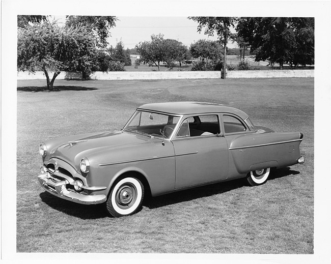 1954 Packard 2-door sedan, three-quarter left side view, parked on grass