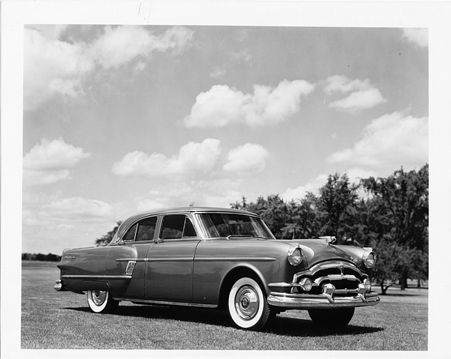 1954 Packard 4-door sedan, three-quarter right side view, parked on grass