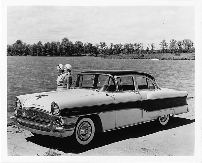 1956 Packard Clipper, three-quarter left side view, two women standing near passenger side