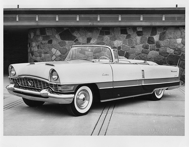 1955 Packard convertible, three-quarter left side view, top folded, parked in driveway