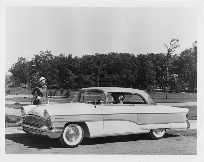 1956 Packard Clipper, woman behind wheel, woman standing at front of car