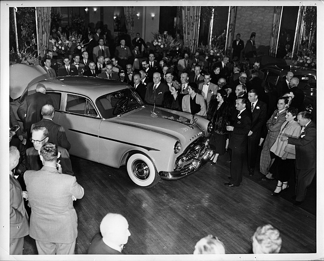 1950 Packard 4-door sedan admired by crowd at automobile show