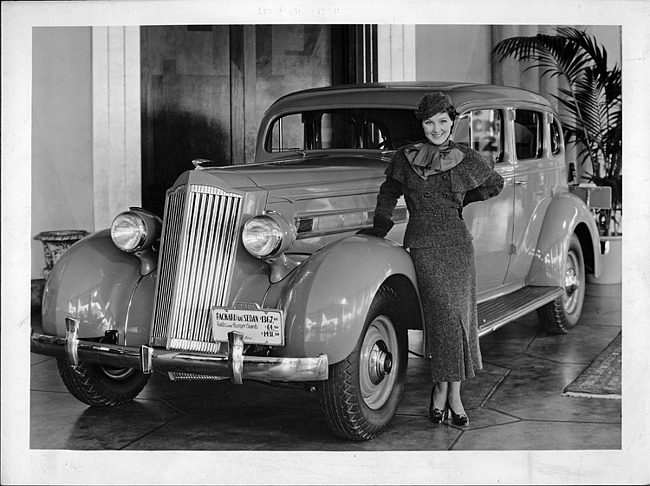 1935 Packard sedan with Miss Jean Parker in Packard dealer showroom