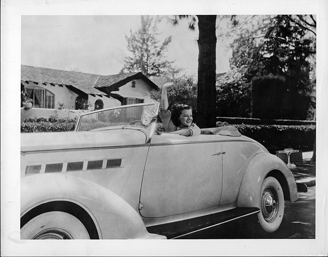 1936 Packard convertible coupe with Dixie Dunbar waving behind wheel
