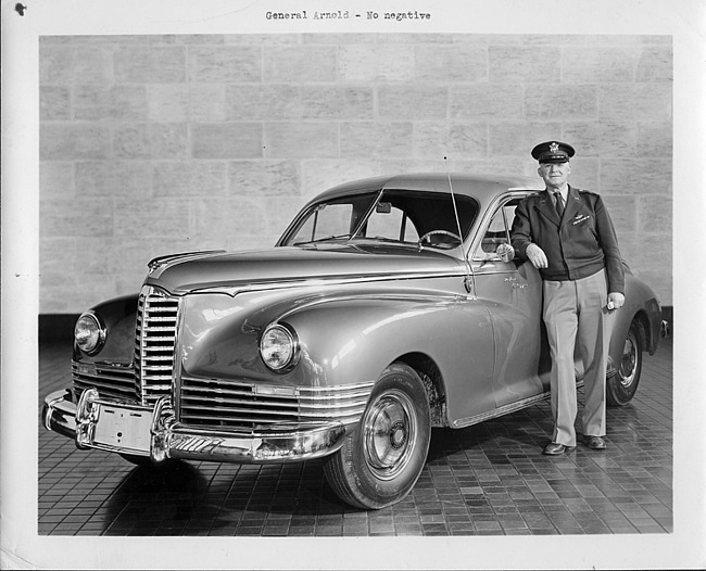 1946-47 Packard touring sedan, owner General Arnold standing at driver's door