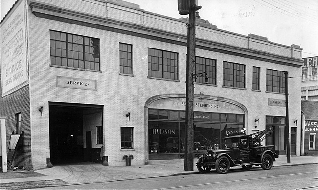 1924 Packard tow truck, three-quarter left side view, parked on street in front of building