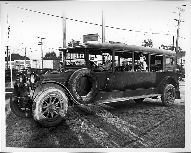 1915-16 Packard jitney bus, parked on street, man behind wheel, two male passengers
