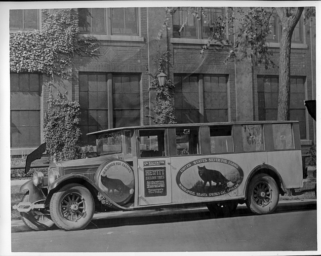 Packard bus belonging to U.S. Silver Fox Farms in front of Packard administration building
