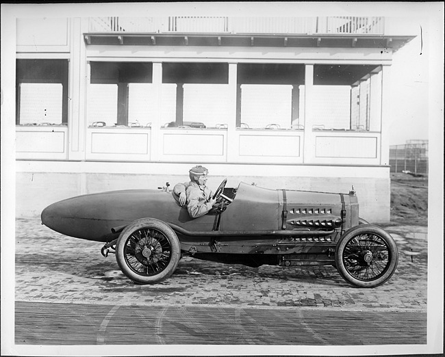 Packard 299 race car, left side view, two men inside