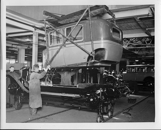 1928 Packard club sedan body being lowered on to chassis at final assembly