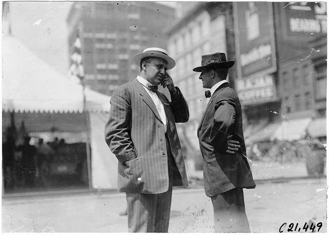 Two men talking near inspection tent, 1909 automobile parade, Detroit, Mich.
