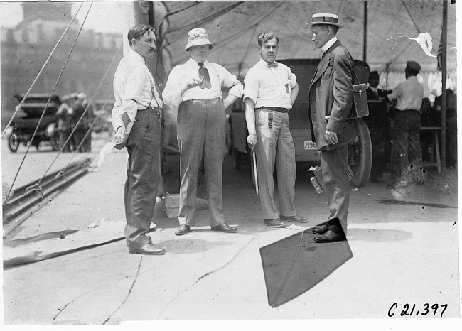Four men talking near inspection tent, 1909 Glidden Tour automobile parade, Detroit, Mich.