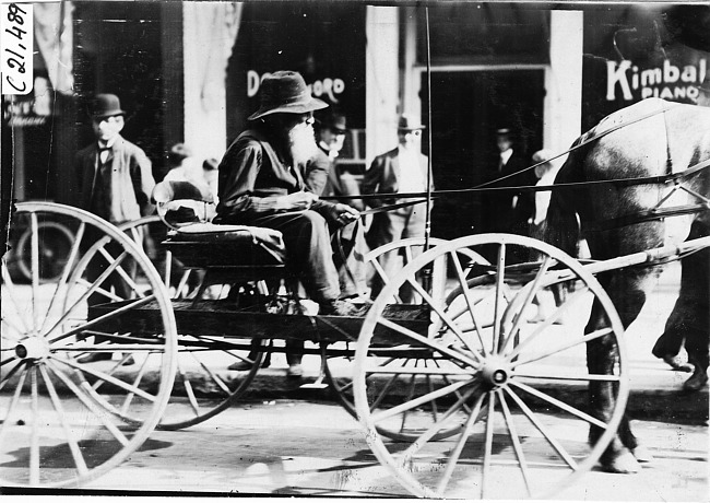 Man sitting in horse-drawn vehicle at the 1909 Glidden Tour