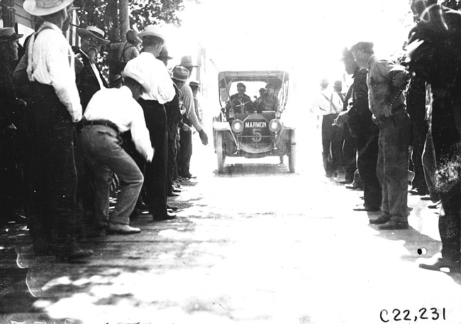 Marmon car surrounded by crowd enters Sauk City, Wis., 1909 Glidden Tour