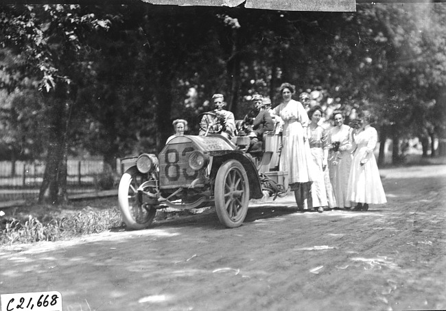 Harry Bill and Harry Ford in Chalmers-Detroit car welcomed to Sauk City, Wis., by women with flowers, at the 1909 Glidden Tour