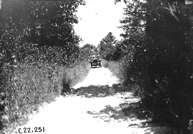 Car driving down a narrow rural road near Union Center, Wis., 1909 Glidden Tour