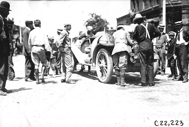 Men adding fluids to car in Elroy, Wis., 1909 Glidden Tour