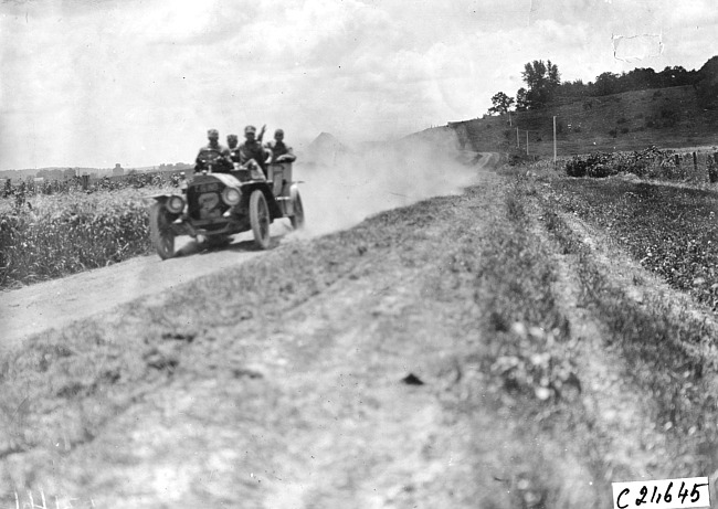 J.D. Hammond in Premier car driving through Pleasant Valley, Minn. at the 1909 Glidden Tour