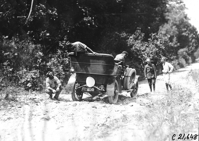 Glidden tourists examine car stopped on rocky road at the 1909 Glidden Tour
