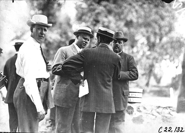 Charles Glidden with a group of men at race track in Minnesota, at the 1909 Glidden Tour