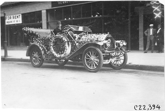 C. Zimmerman in decorated Oldsmobile car for parade in Minnesota, at the 1909 Glidden Tour