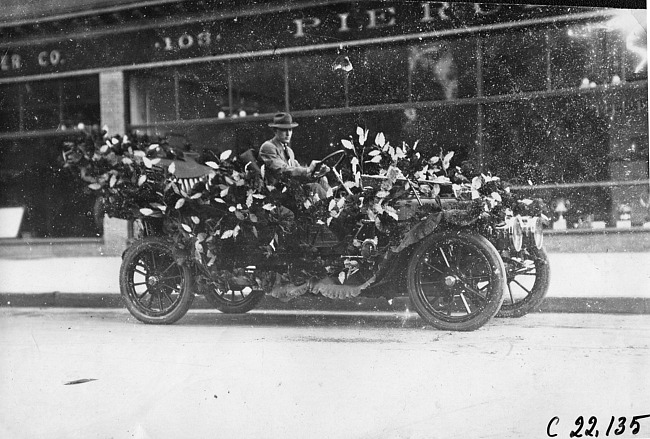 John S. John in decorated Winton car for parade in Minnesota, at the 1909 Glidden Tour