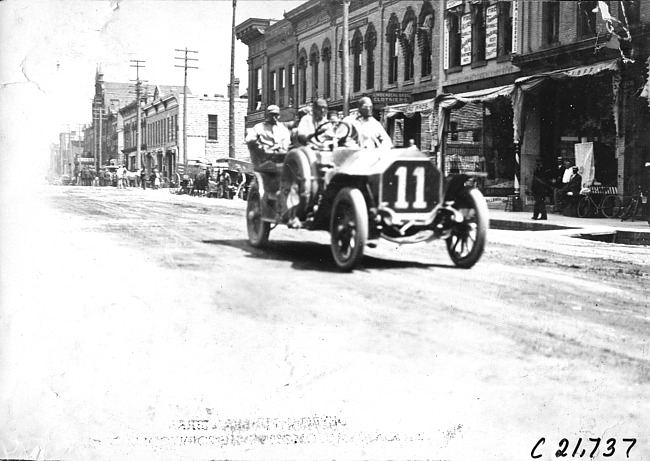 Gus Buse in Thomas car passing through Faribault, Minn., at 1909 Glidden Tour