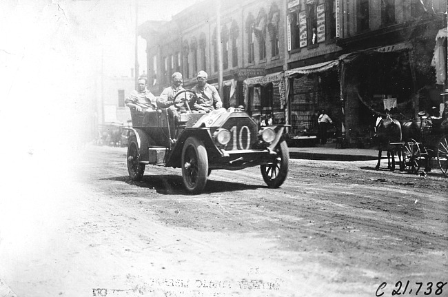 A.Y. Bartholomew in Glide car passing through Faribault, Minn., at 1909 Glidden Tour