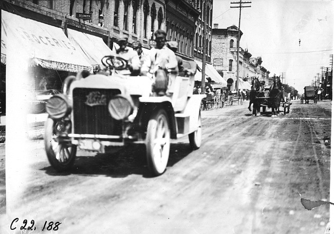 Searles in White Steamer car passing through Faribault, Minn., at 1909 Glidden Tour