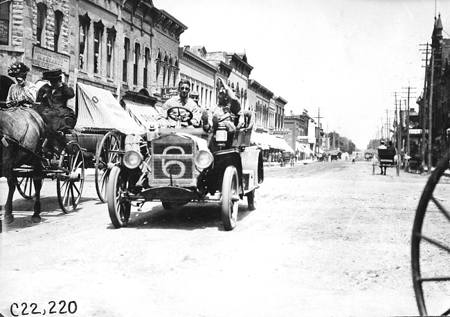Glidden tourists in Maxwell car passing through Madison Lake, Minn., at 1909 Glidden Tour